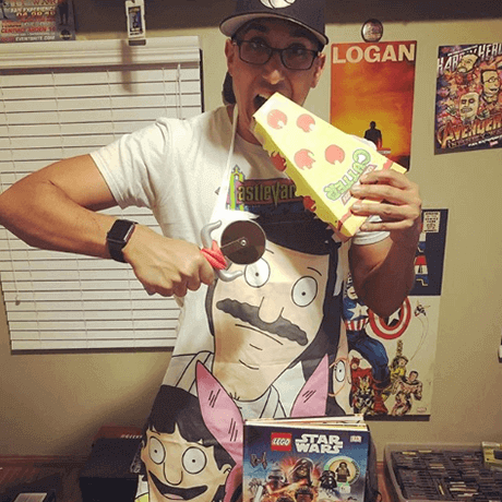 Geek Fuel unboxer with Bobs Burgers apron and Ninja Turtles pizza cutter